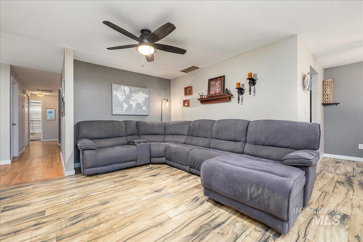 Living room featuring ceiling fan and light wood finished floors