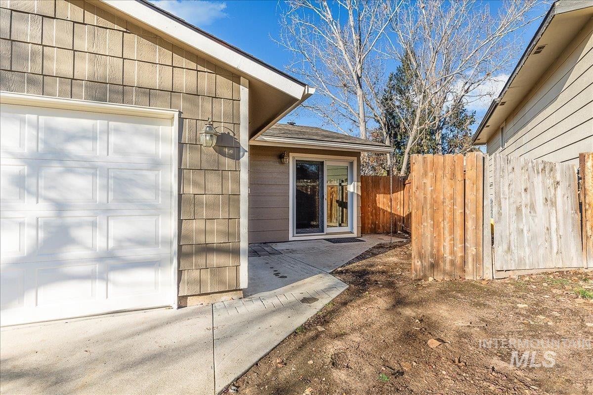 View of exterior entry with a patio area