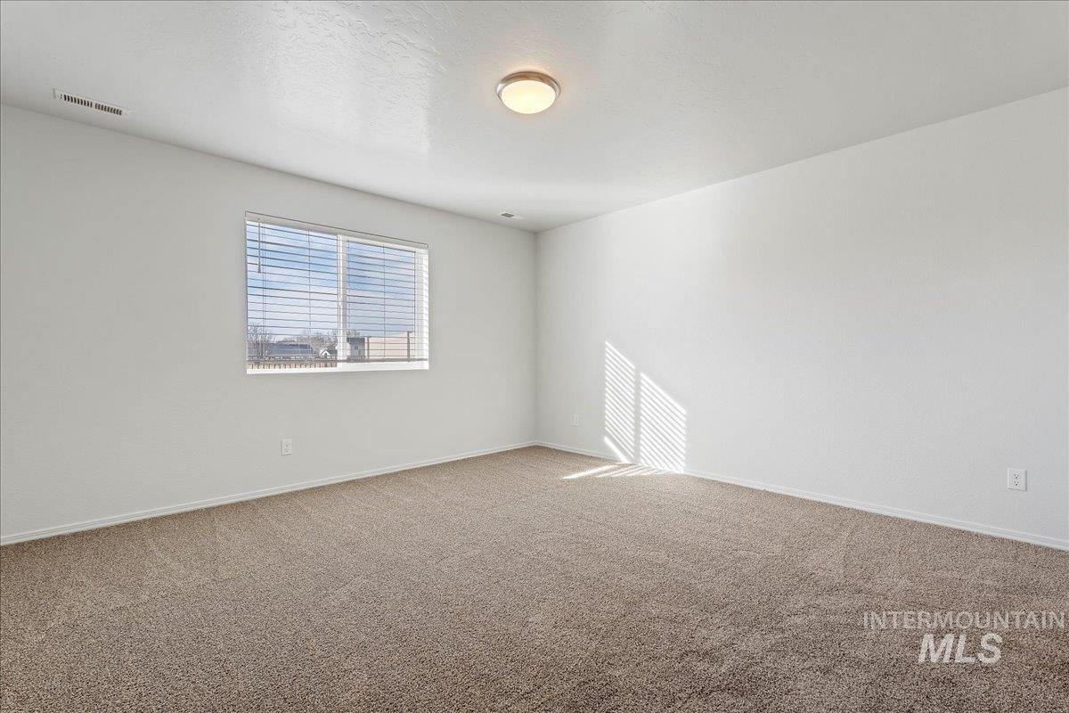 Spare room with carpet and a textured ceiling
