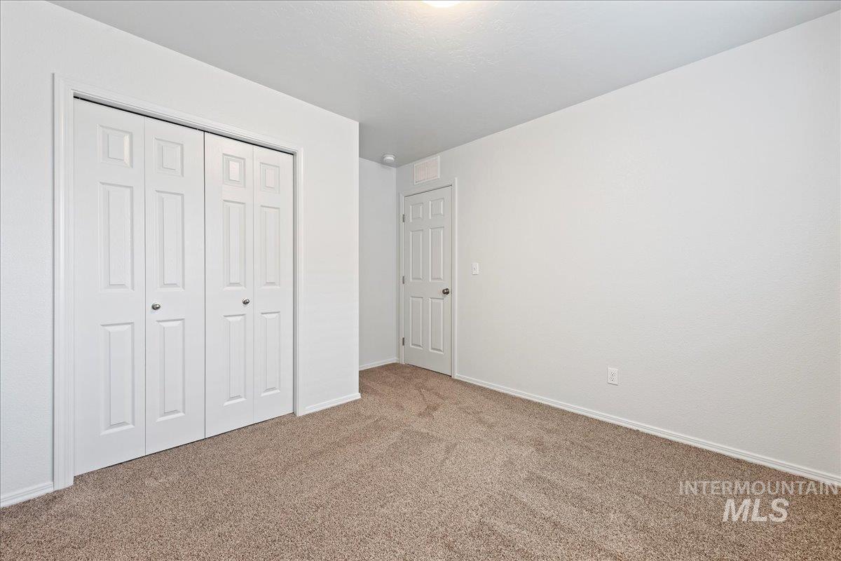 Unfurnished bedroom with carpet floors and a closet