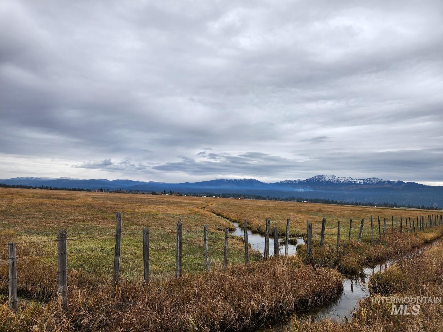 View of mountain background featuring rural landscape and a nearby body of water