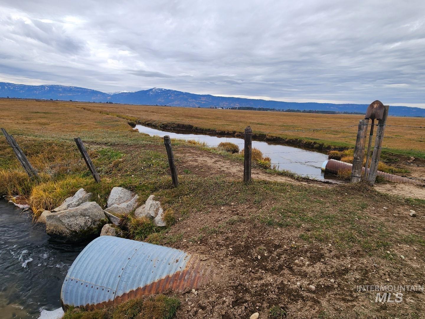View of yard with a rural view and a water and mountain view
