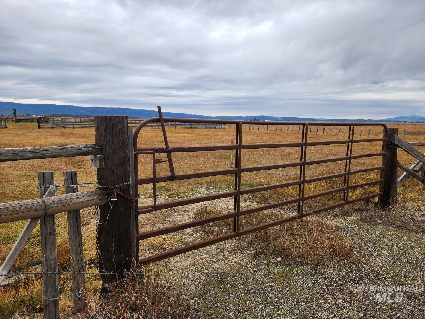 Gate featuring a rural view and a mountain view