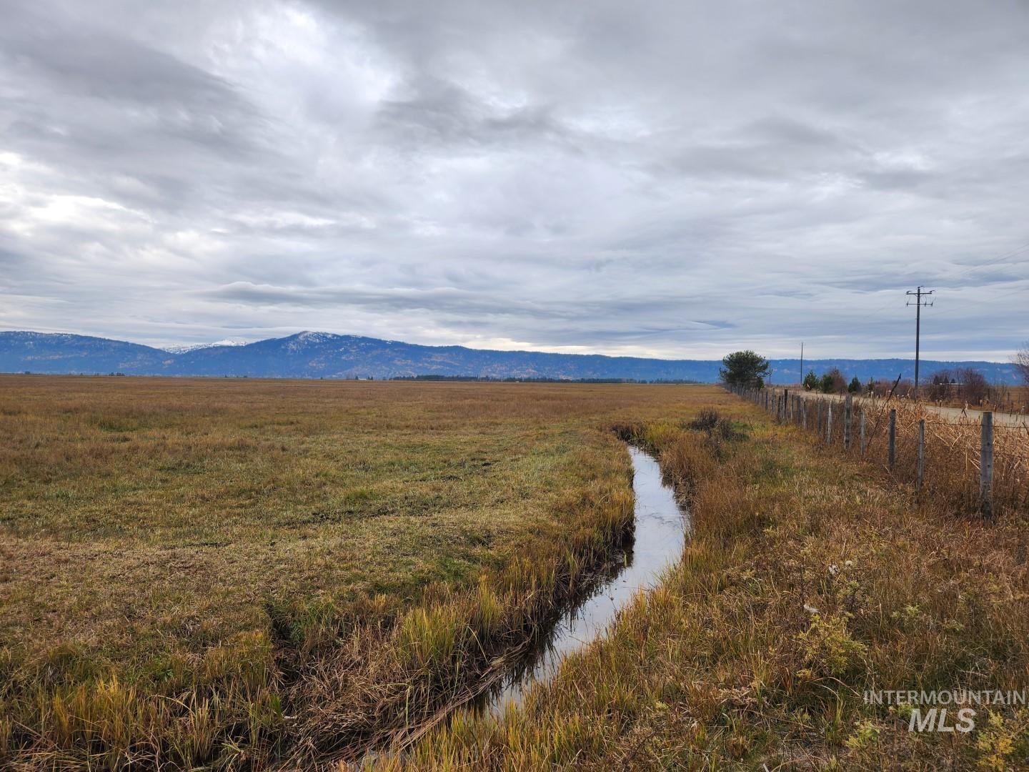 View of mountain backdrop with rural landscape