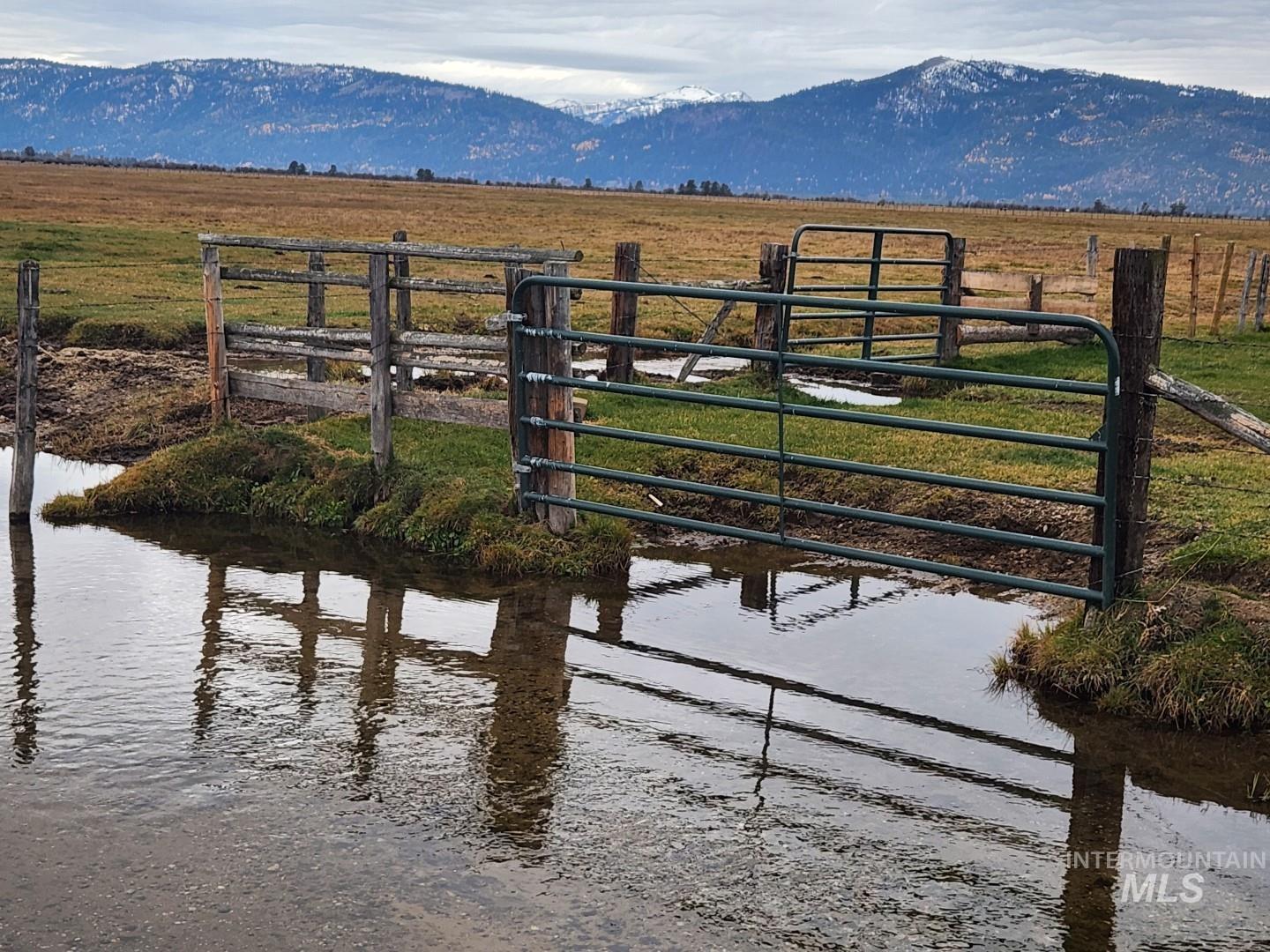 View of mountain backdrop featuring rural landscape and a large body of water