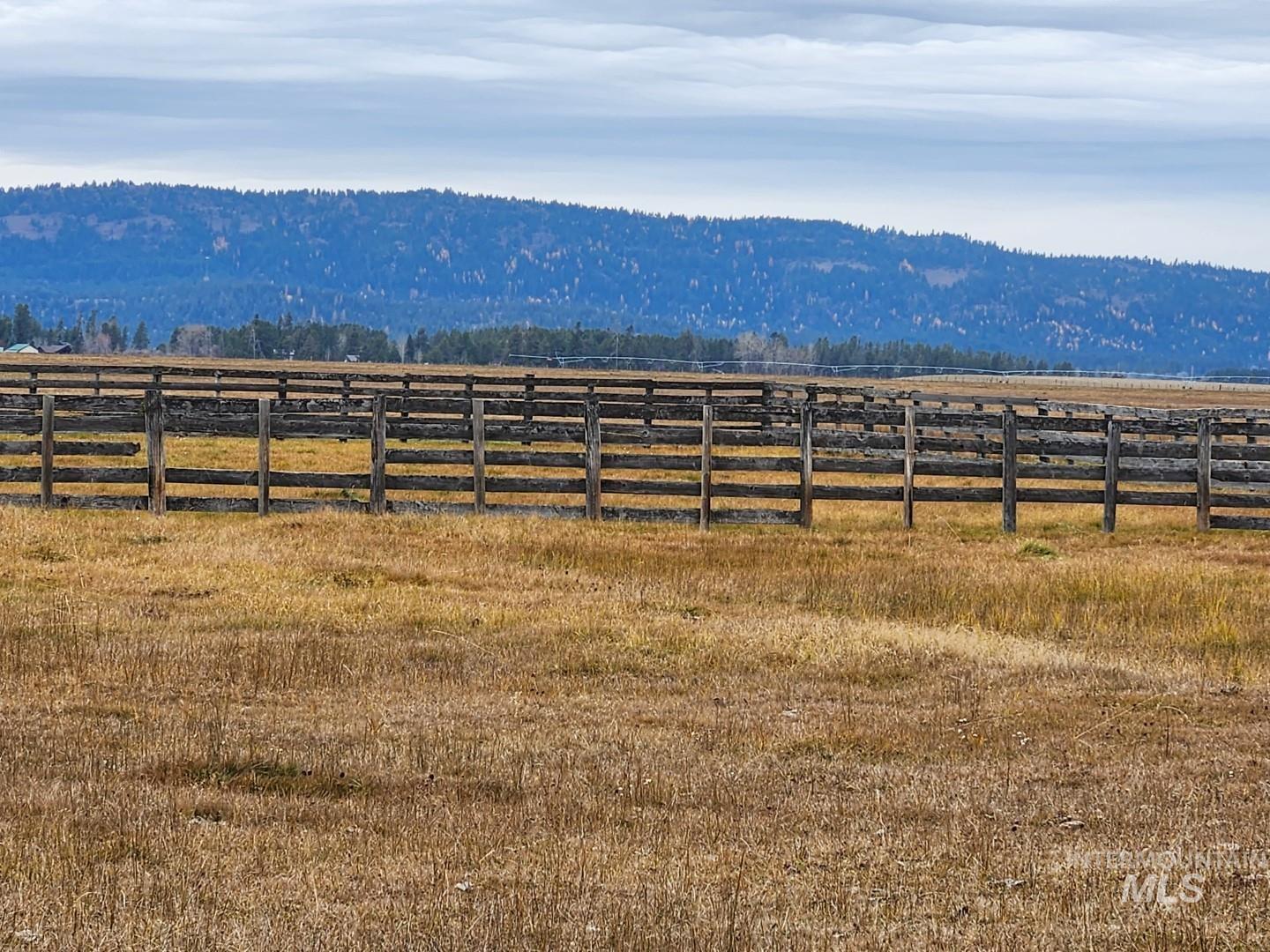 View of mountain backdrop featuring rural landscape and a heavily wooded area