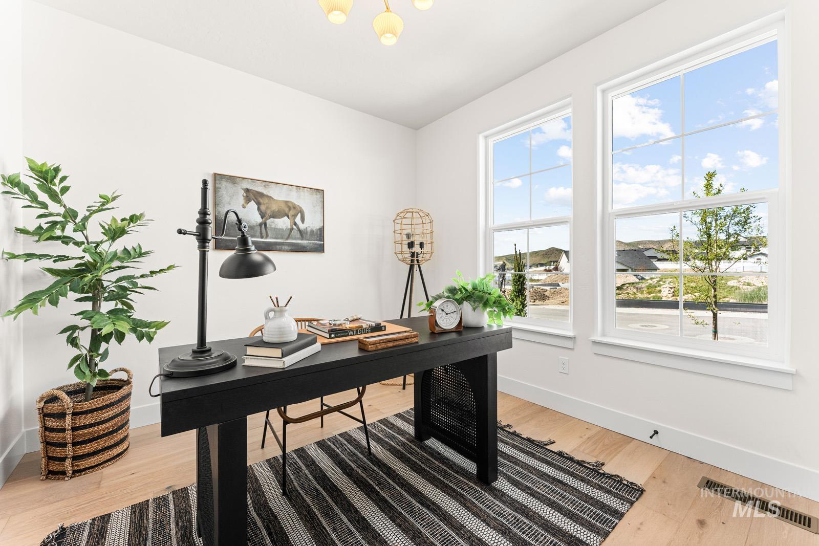 Office with baseboards and light wood-style flooring