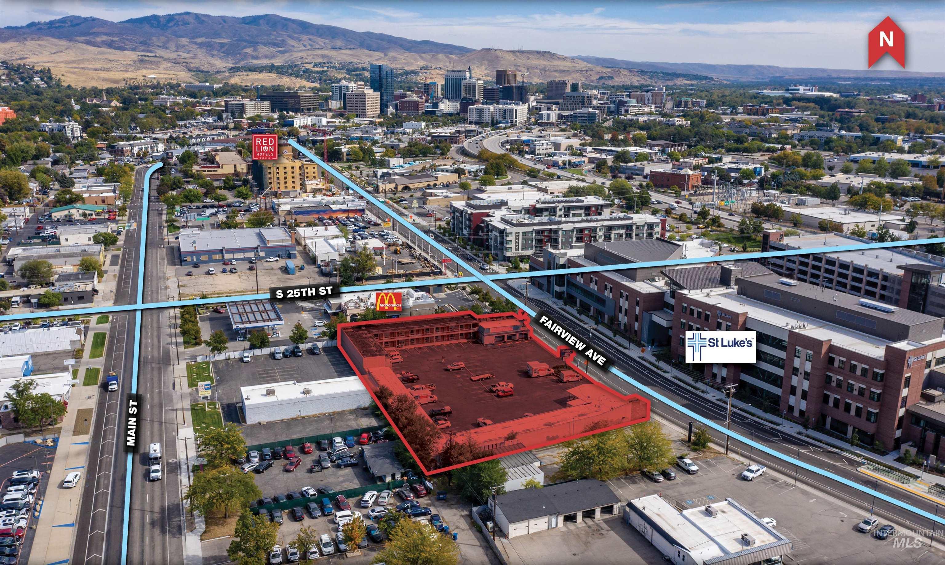 View of urban area with property boundaries highlighted and a mountain backdrop