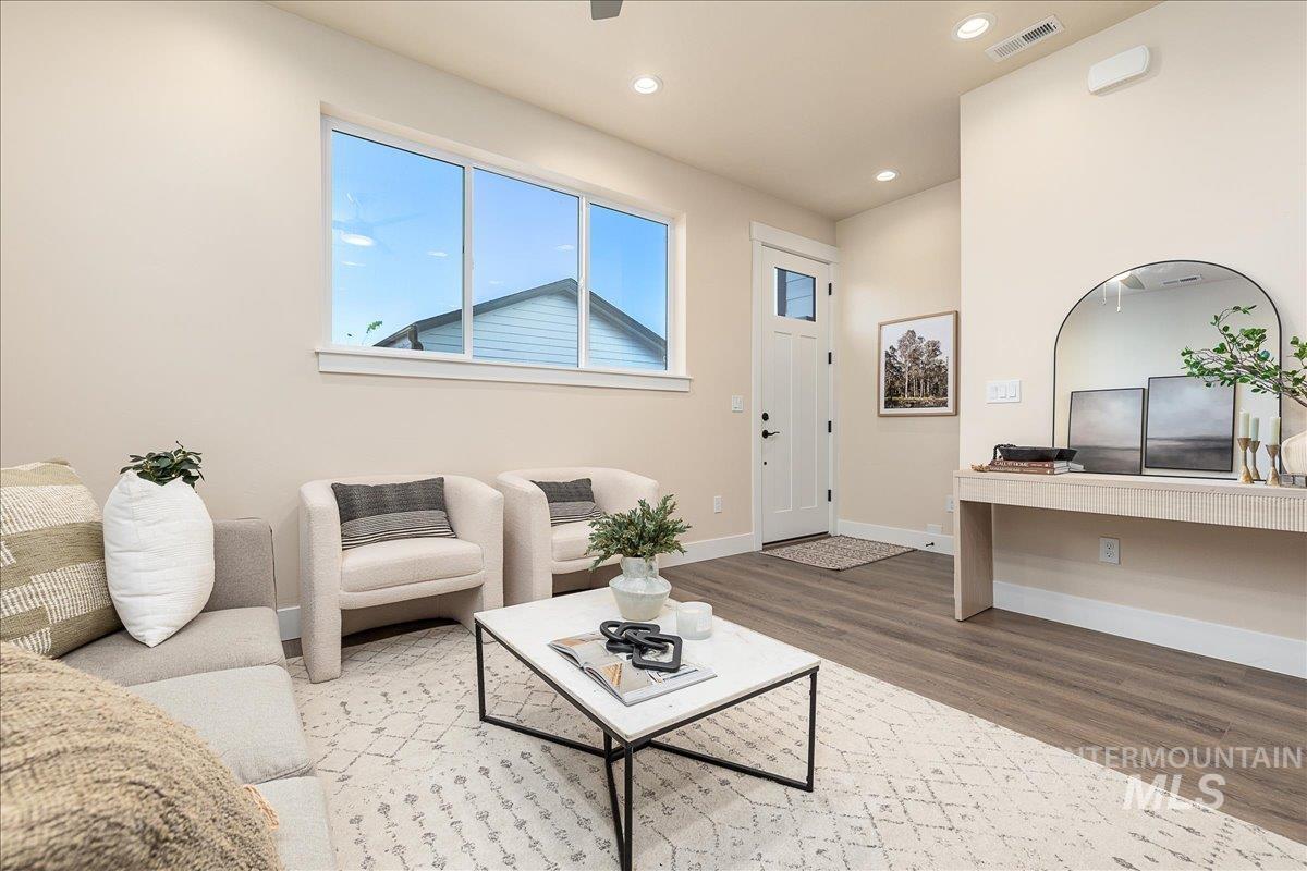Living area featuring wood finished floors and recessed lighting