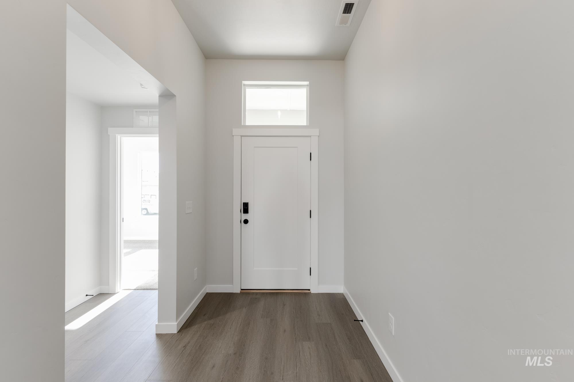 Foyer featuring baseboards and wood finished floors