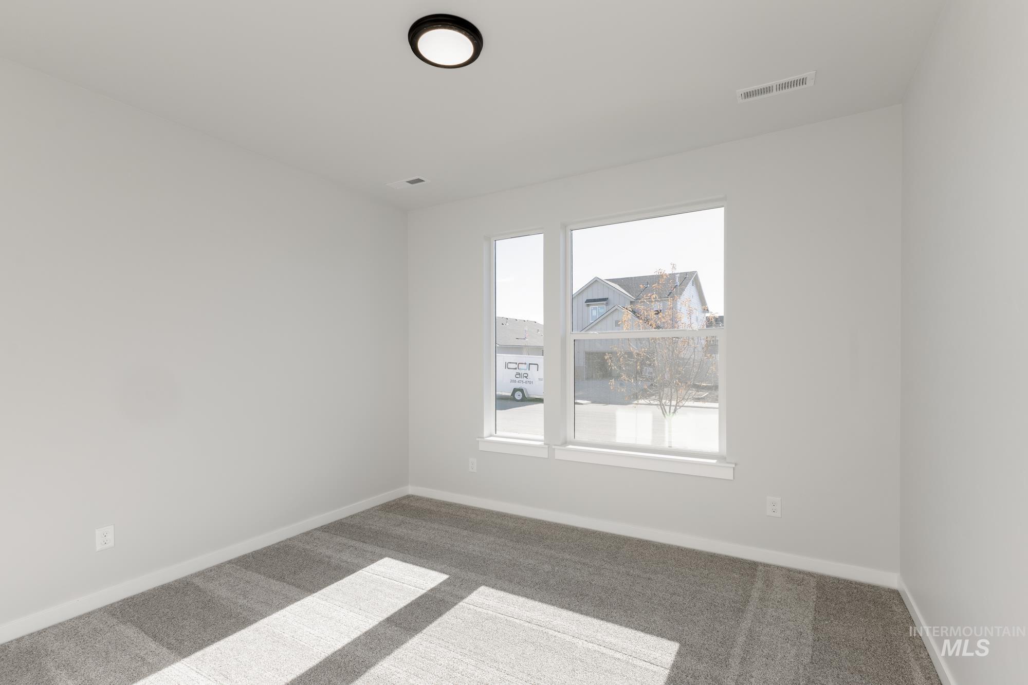 Unfurnished room with carpet and baseboards
