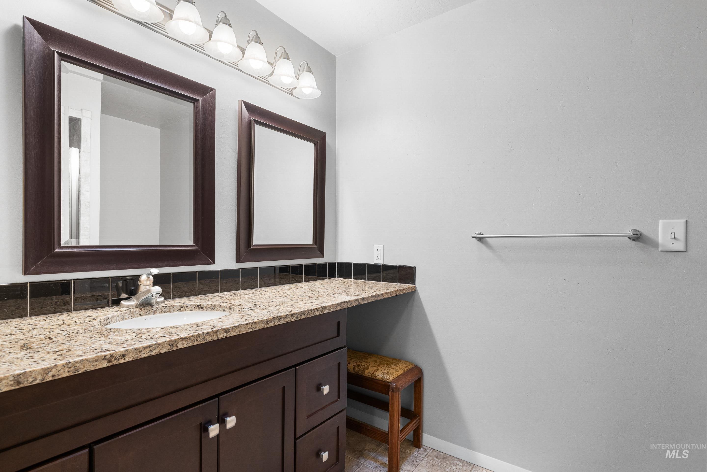 Bathroom with vanity and baseboards