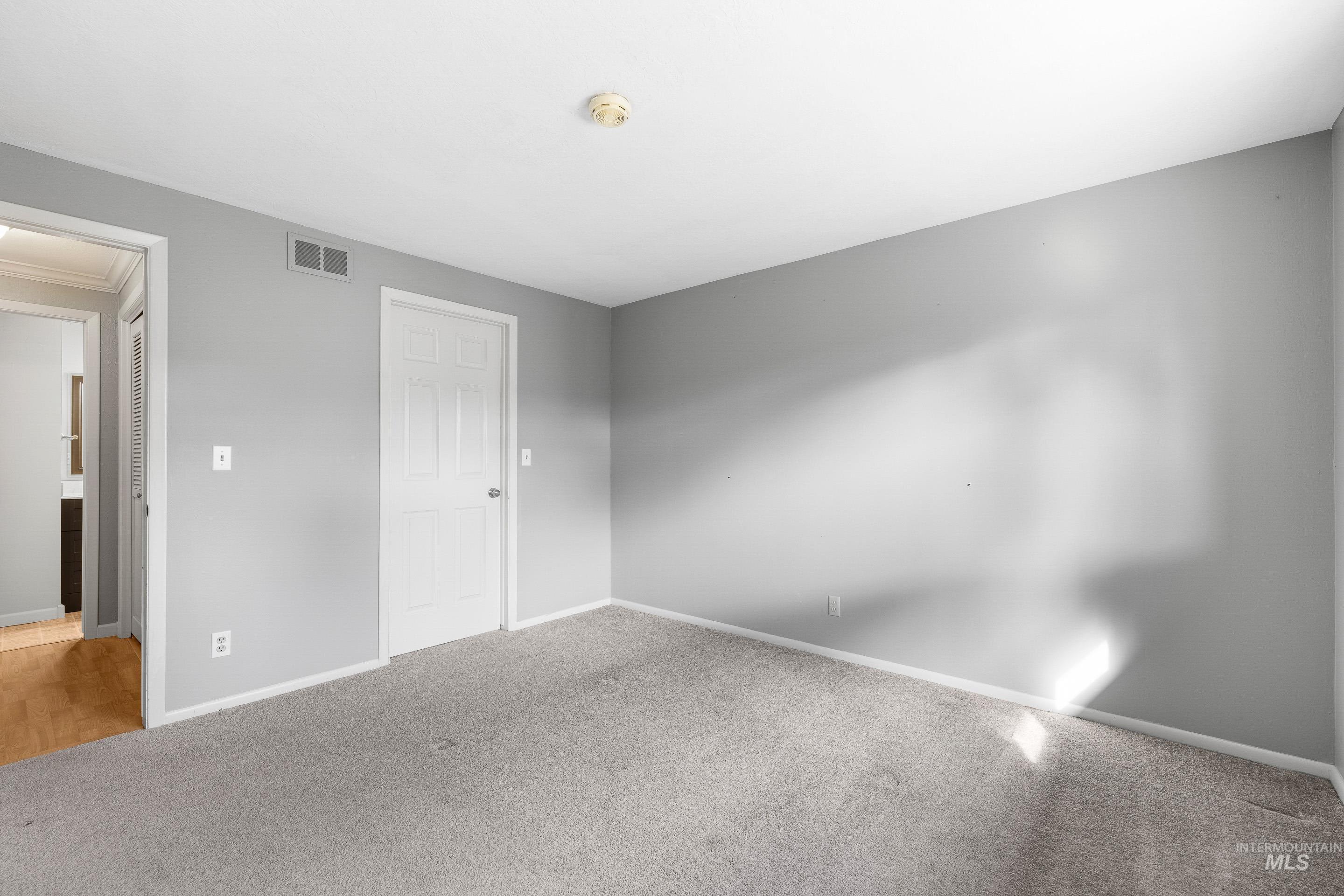 Unfurnished bedroom featuring carpet flooring and baseboards