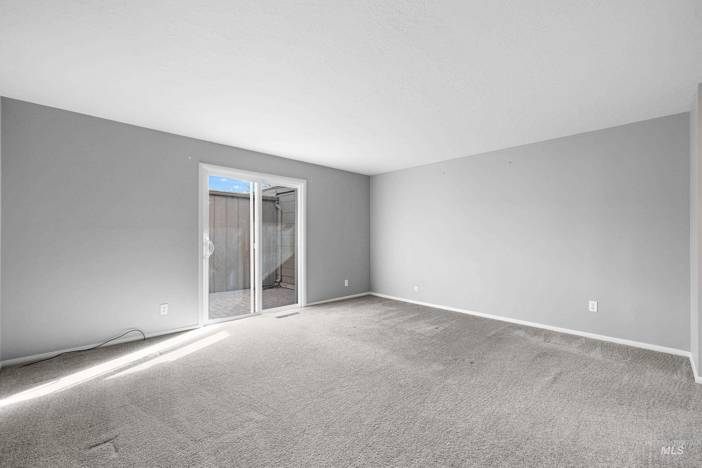 Unfurnished room featuring carpet and baseboards