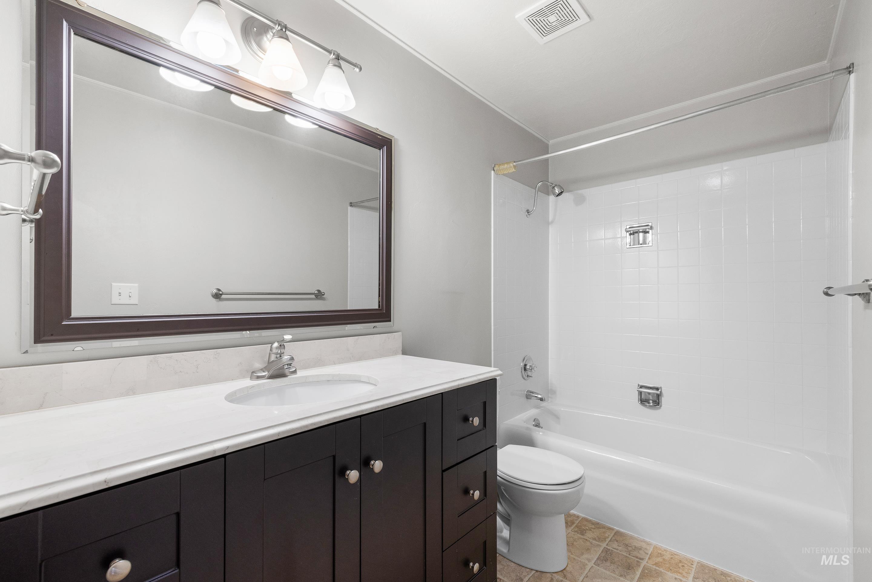 Bathroom featuring vanity and bathtub / shower combination