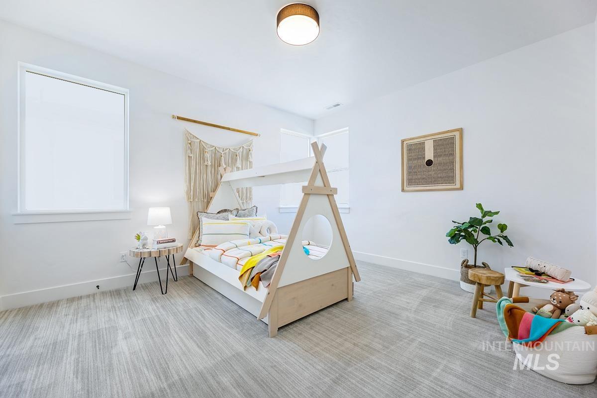 Bedroom with carpet flooring and baseboards