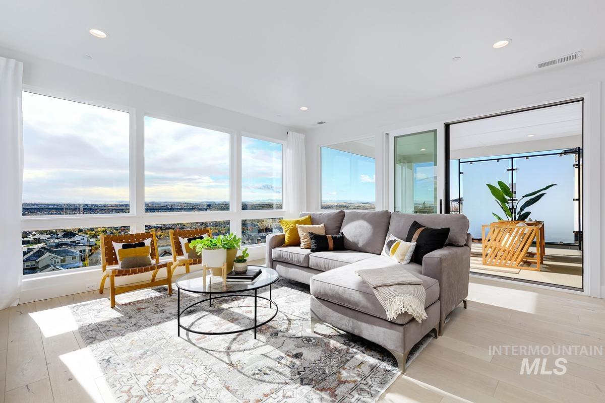 Living area with light wood-style flooring, recessed lighting, and healthy amount of natural light