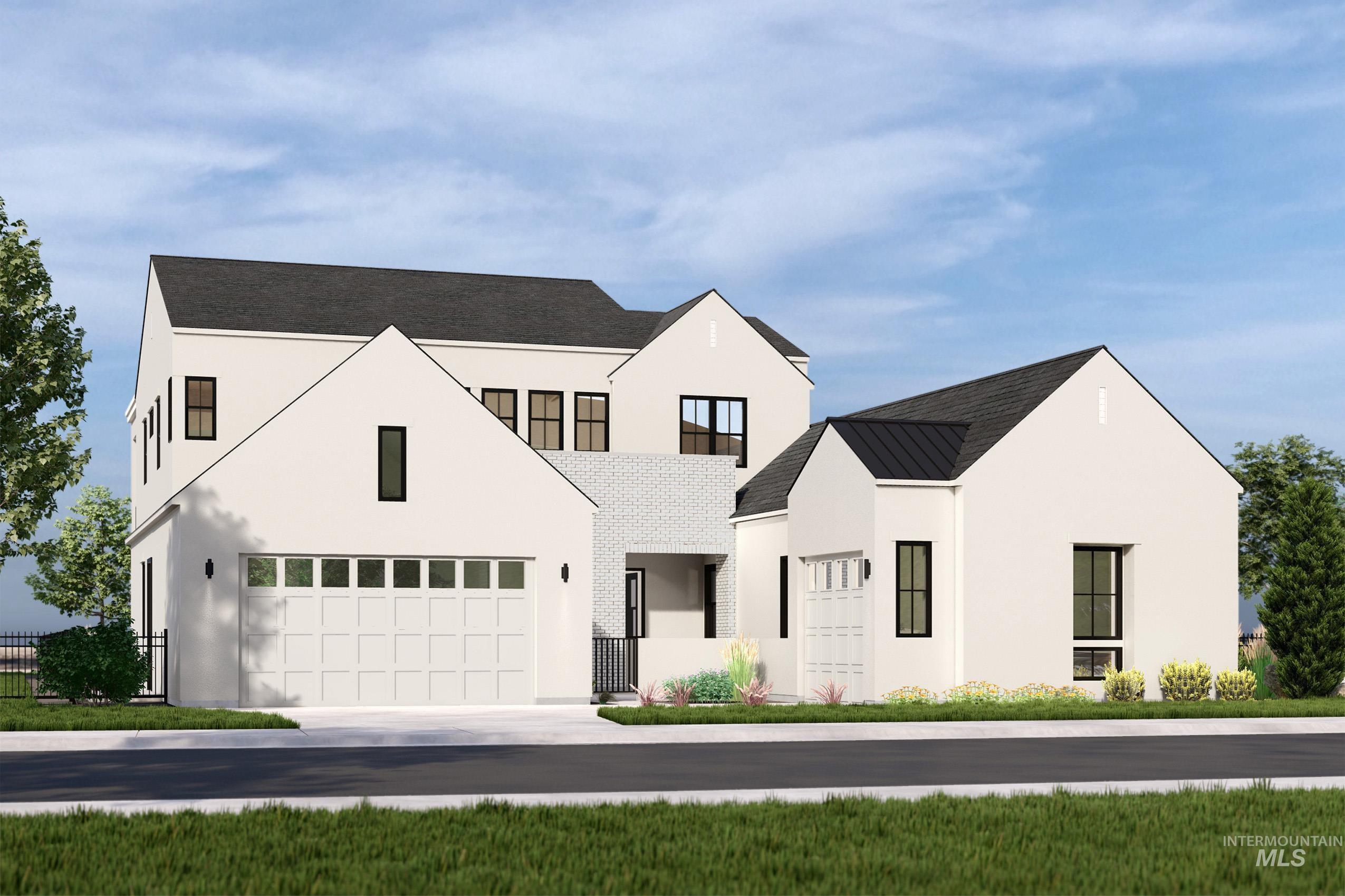 Modern farmhouse with a garage, stucco siding, driveway, and a standing seam roof