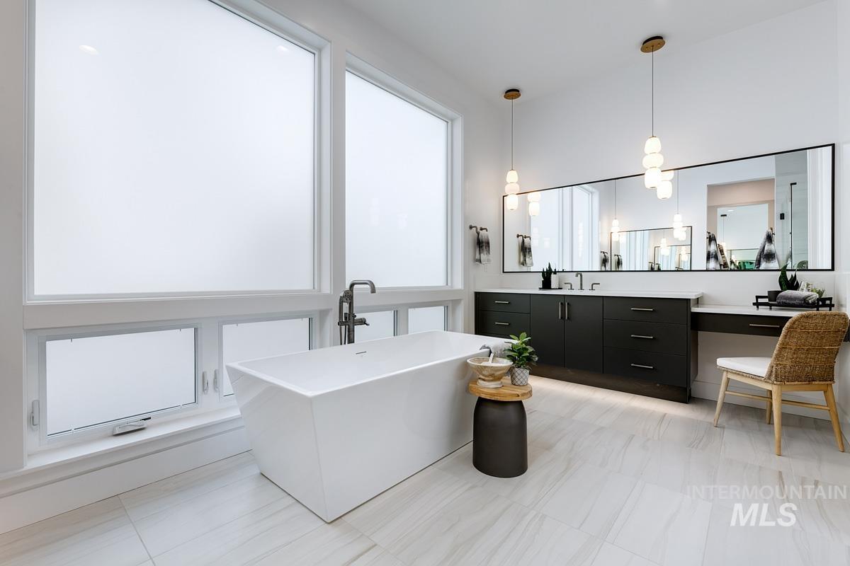 Full bath with vanity and a soaking tub