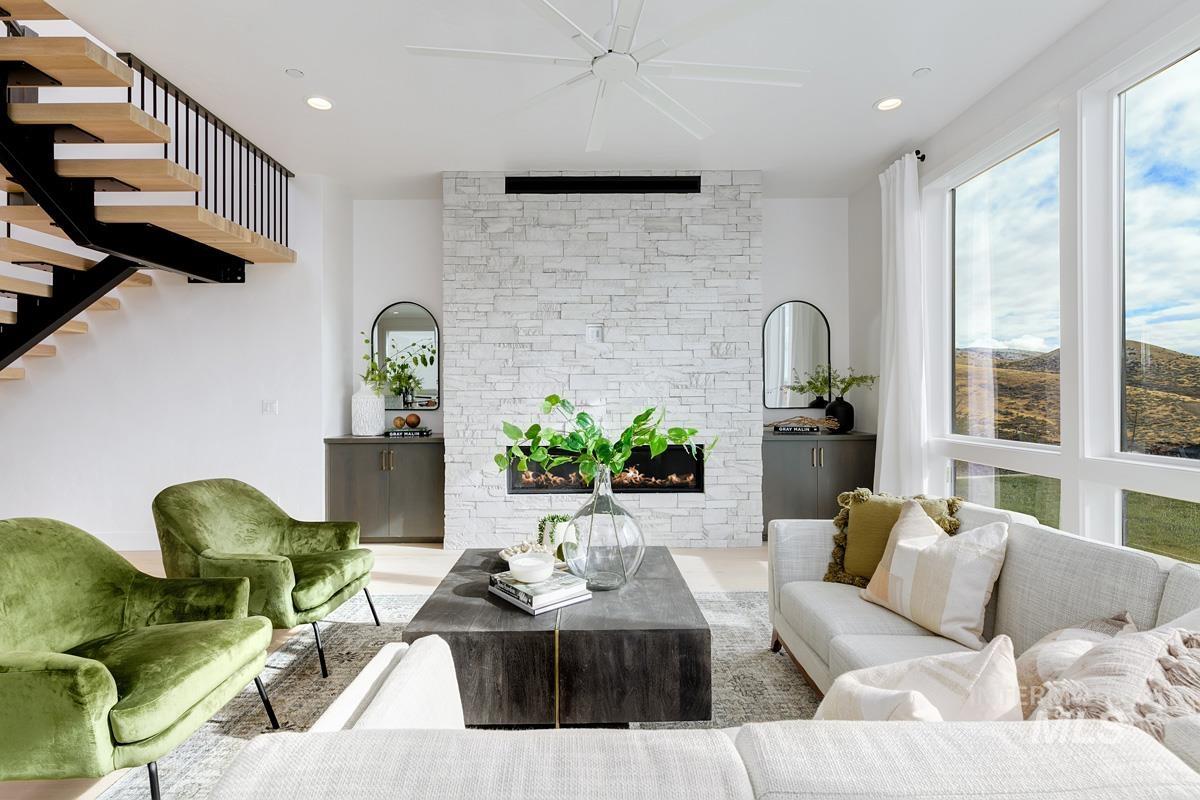 Living room featuring a fireplace, recessed lighting, stairs, and wood finished floors