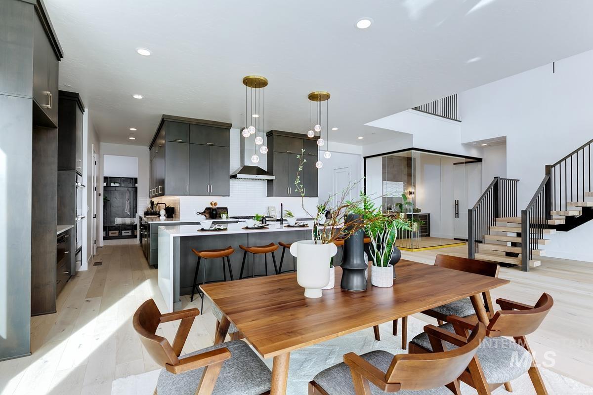 Dining area featuring light wood finished floors, stairway, and recessed lighting