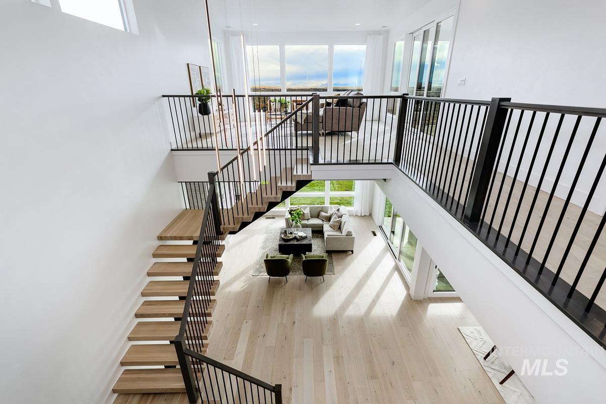 Stairs featuring wood finished floors