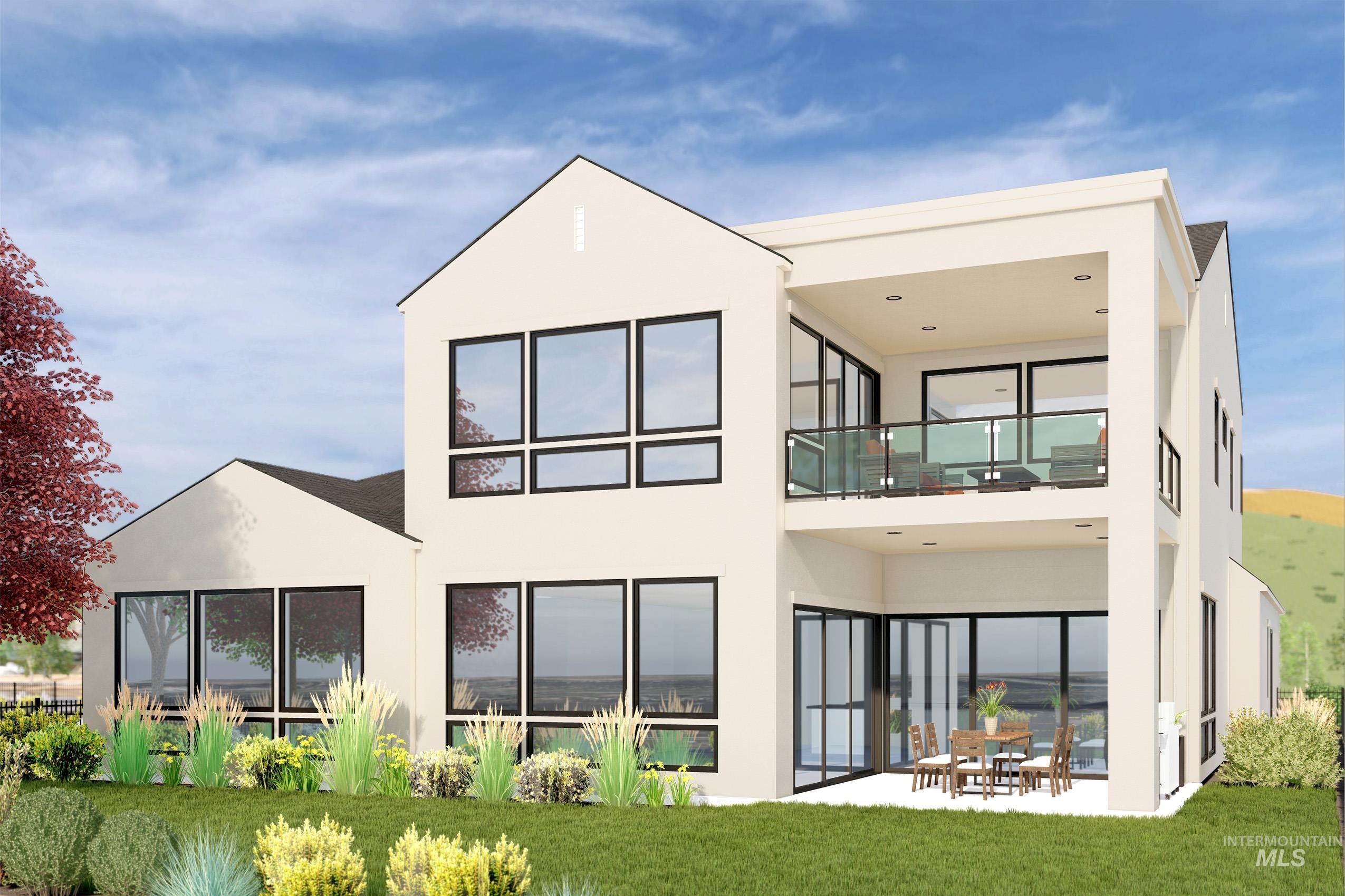 Back of house featuring a patio, a balcony, stucco siding, and a yard