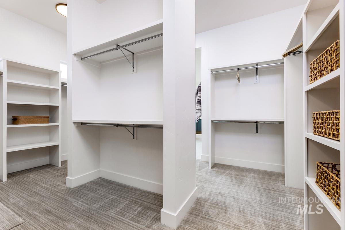 Spacious closet with light colored carpet