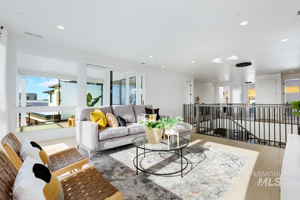 Living room with recessed lighting and wood finished floors