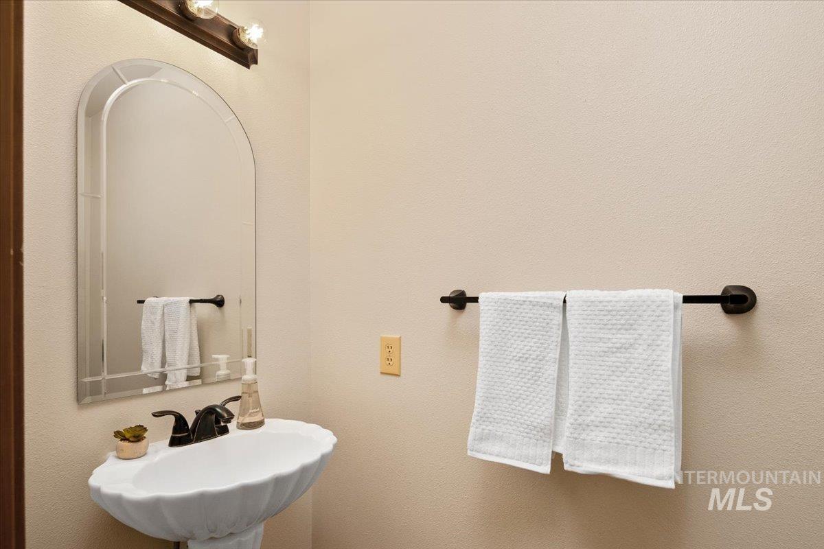 Bathroom featuring a sink and a textured wall