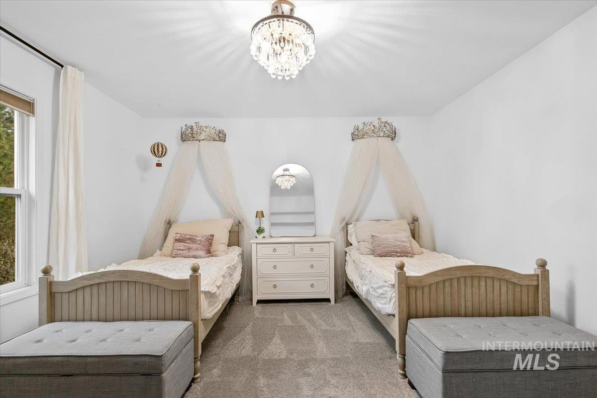 Carpeted bedroom with a chandelier