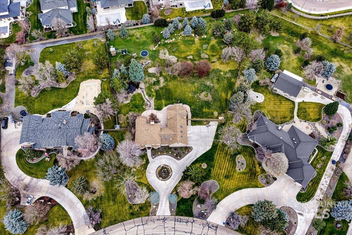 Aerial view of property and surrounding area with nearby suburban area