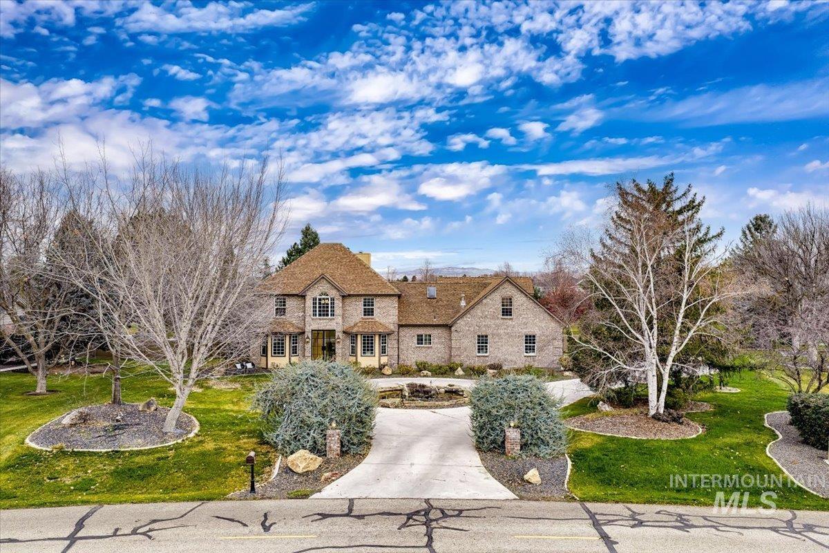 View of front of house with a front yard and a chimney