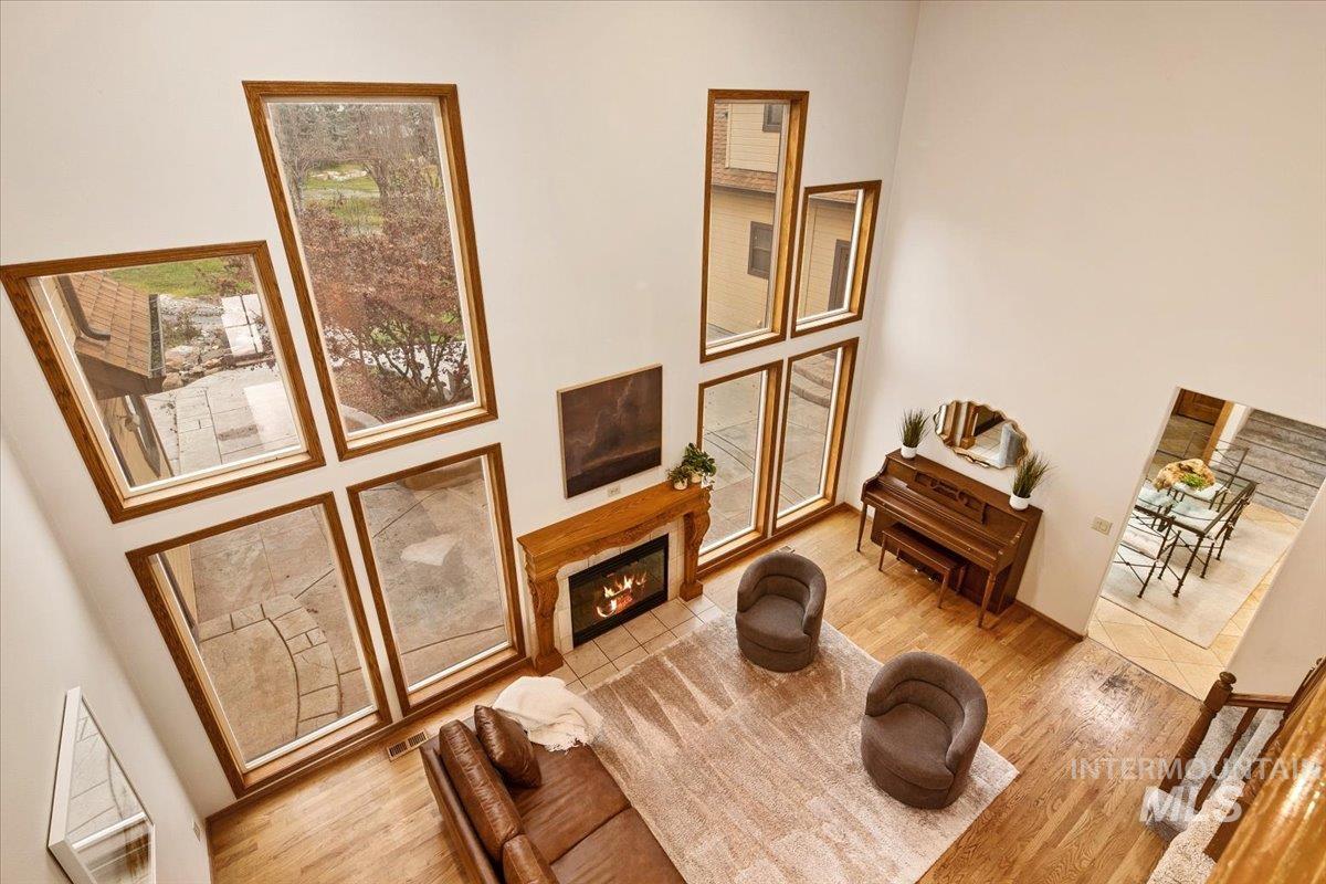 Living area featuring wood finished floors and a fireplace with flush hearth