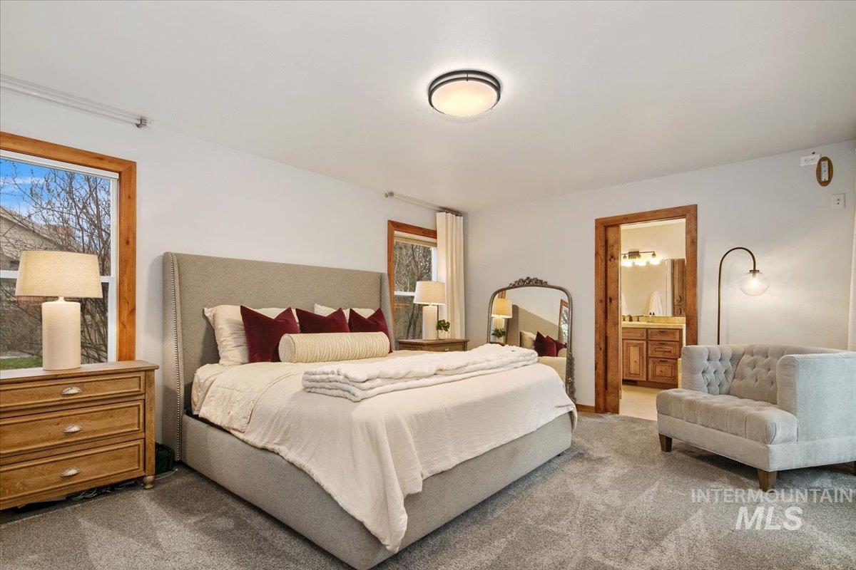 Bedroom featuring carpet flooring and connected bathroom