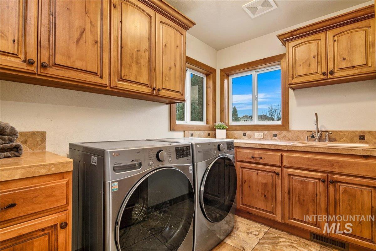 Laundry room with cabinet space and washing machine and clothes dryer