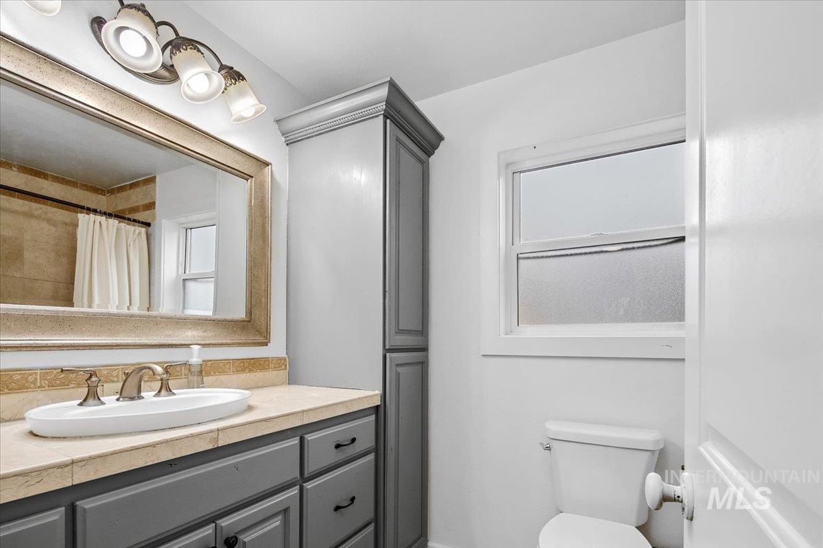 Full bathroom with vanity and a shower with shower curtain