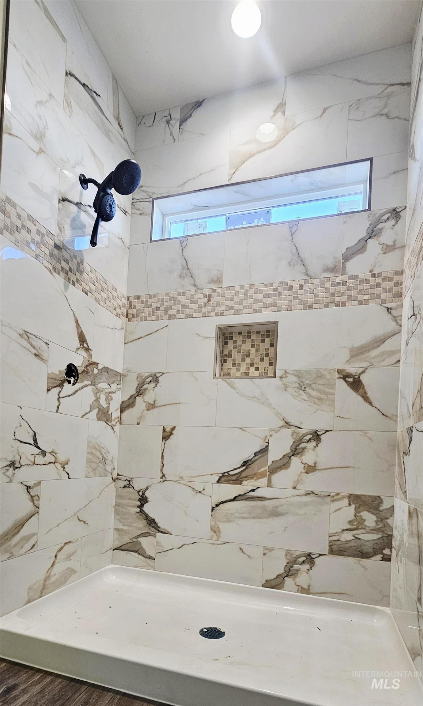 Bathroom featuring tiled shower