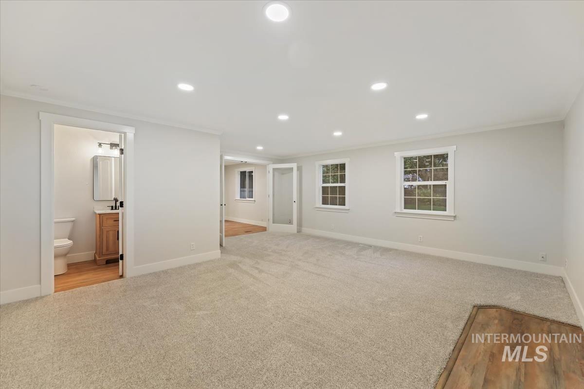 Empty room with recessed lighting, ornamental molding, and light colored carpet