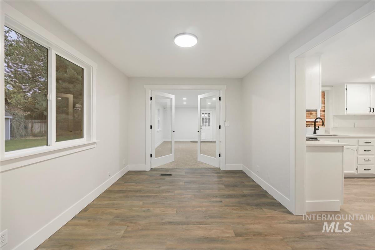 Hallway featuring baseboards and light wood-type flooring