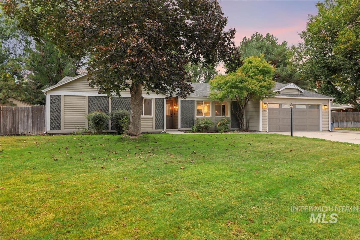 View of front of property with concrete driveway and a garage
