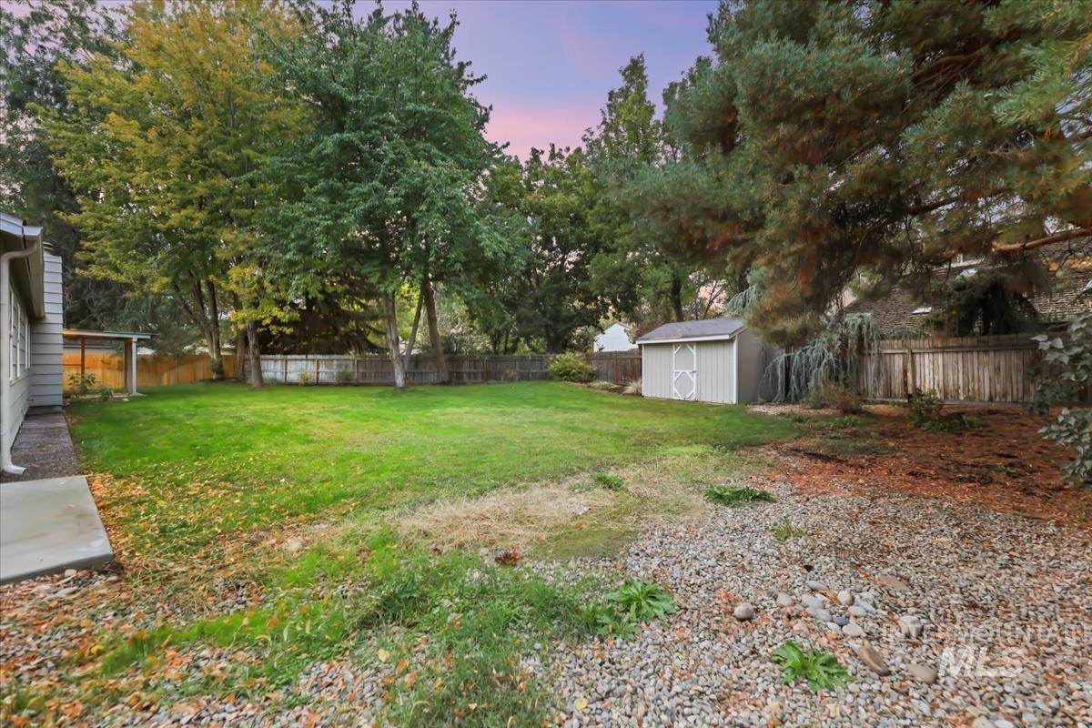 Fenced backyard with a storage shed