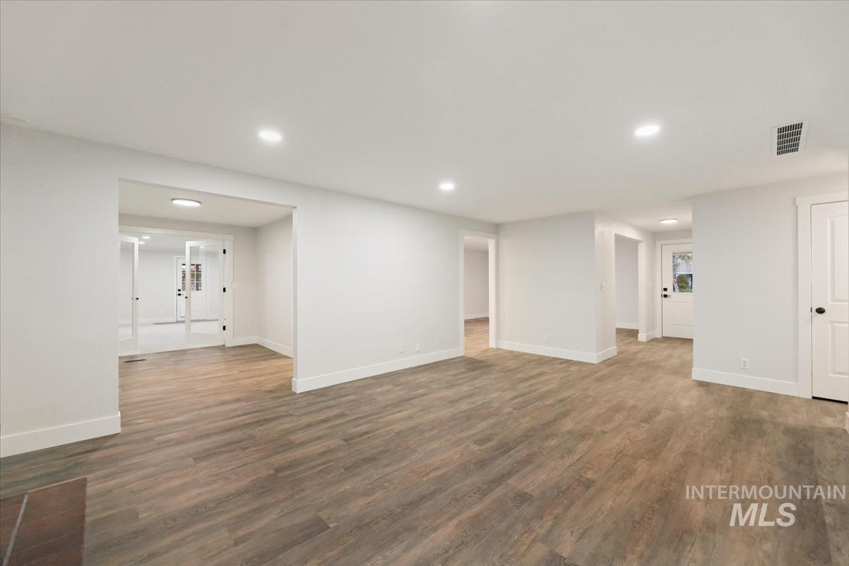 Unfurnished living room with wood finished floors and recessed lighting