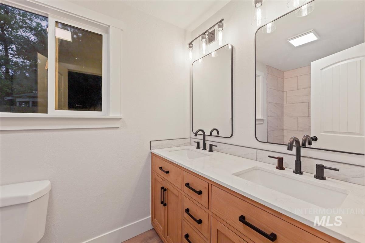 Bathroom with double vanity and toilet