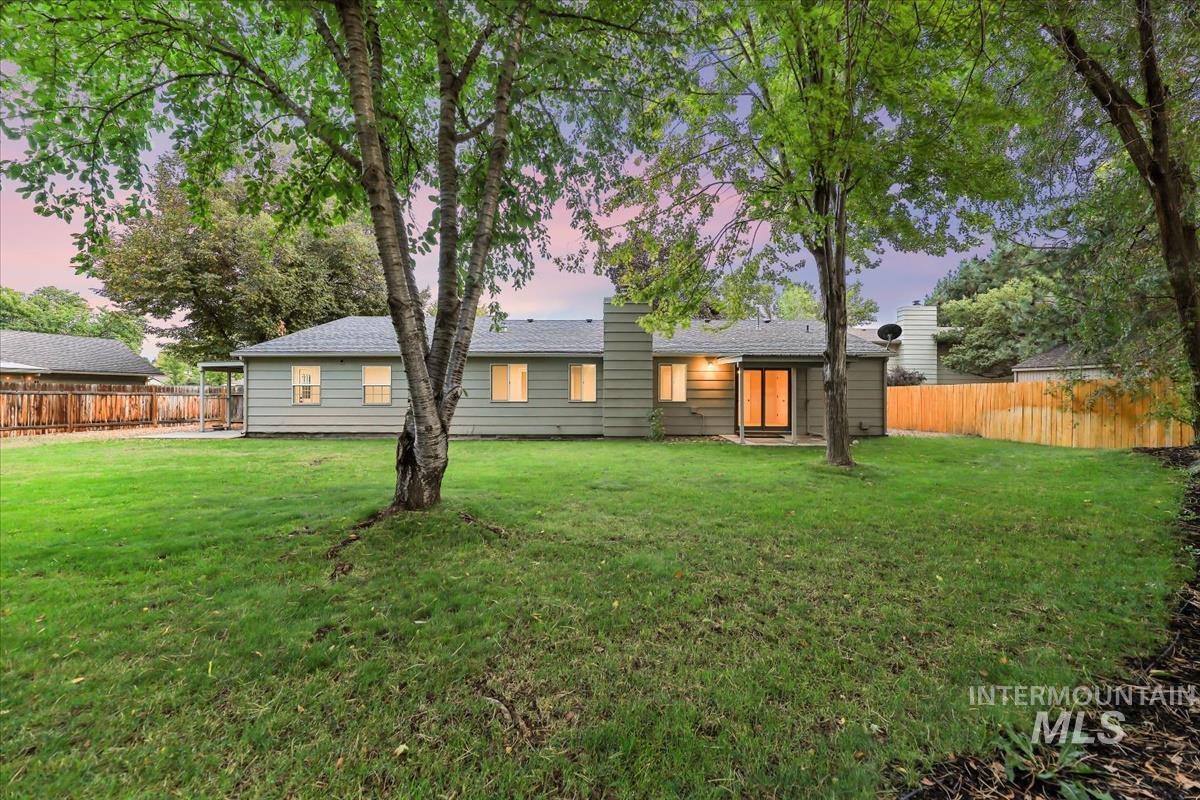 Rear view of property featuring a fenced backyard and a patio