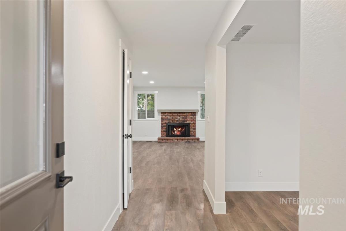 Corridor featuring light wood-style floors and recessed lighting