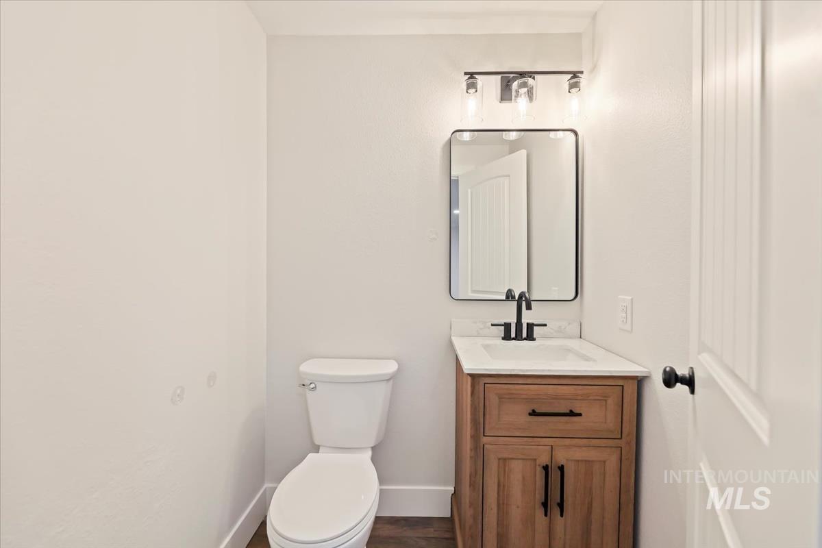 Bathroom with vanity and dark wood-type flooring