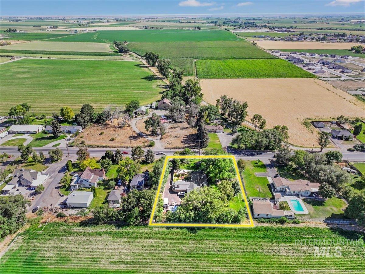 Overview of rural landscape with property boundaries highlighted and rows of crops