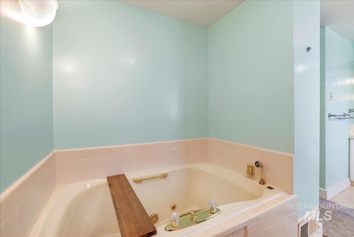 Full bath featuring a bath