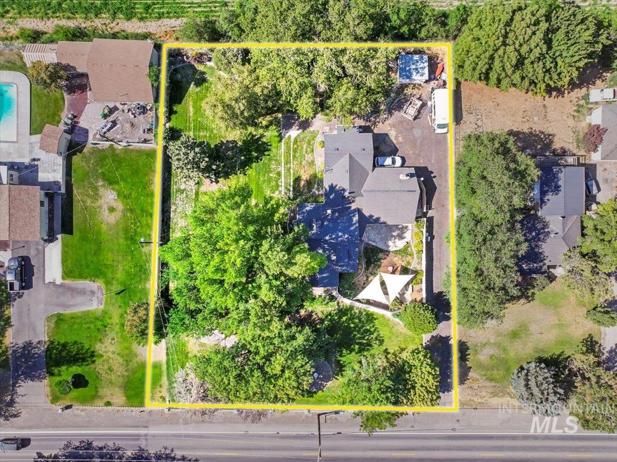 Aerial view of property and surrounding area with property parcel outlined